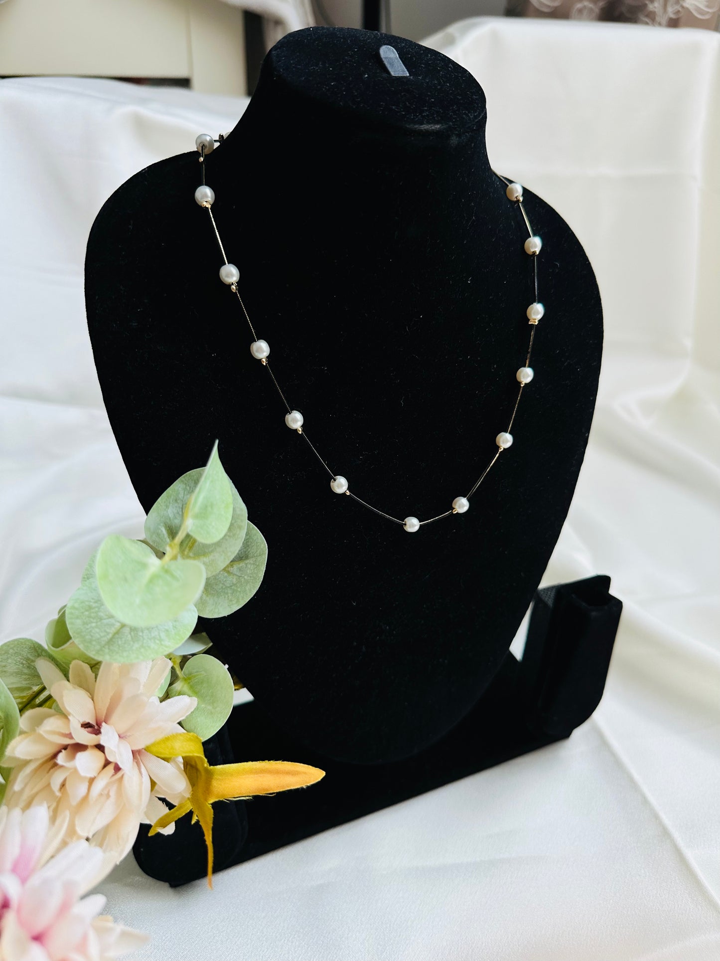 Black and gold coloured multi shaded chain Necklace with White coloured Pearl (Faux) placed at equidistance. Elegant Statement Jewellery with adjustable hook and chain.