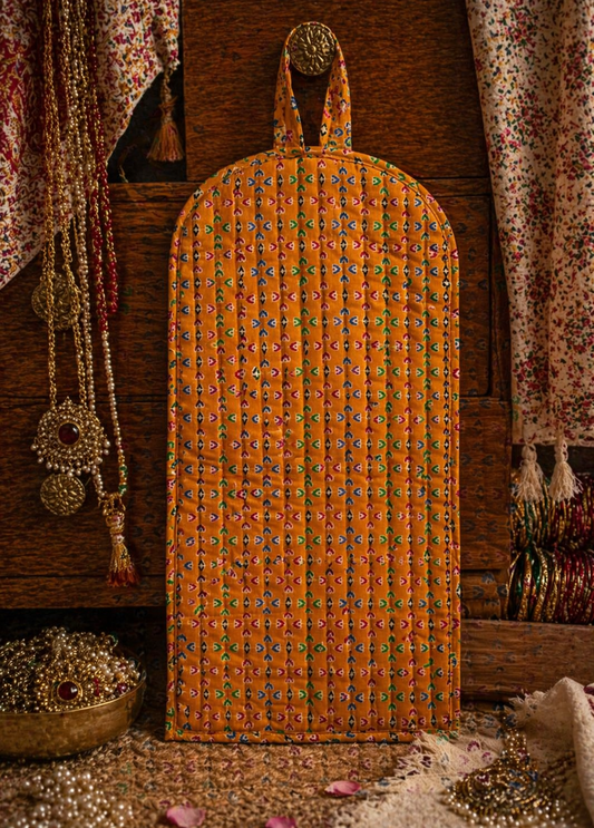 Decorative orange exterior of jewellery stacker/organiser cover with intricate patterns on a wooden background.